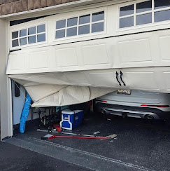 Bent and broken garage door panel awaiting repair